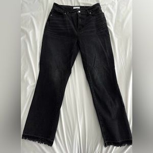 Black jeans with frayed bottoms